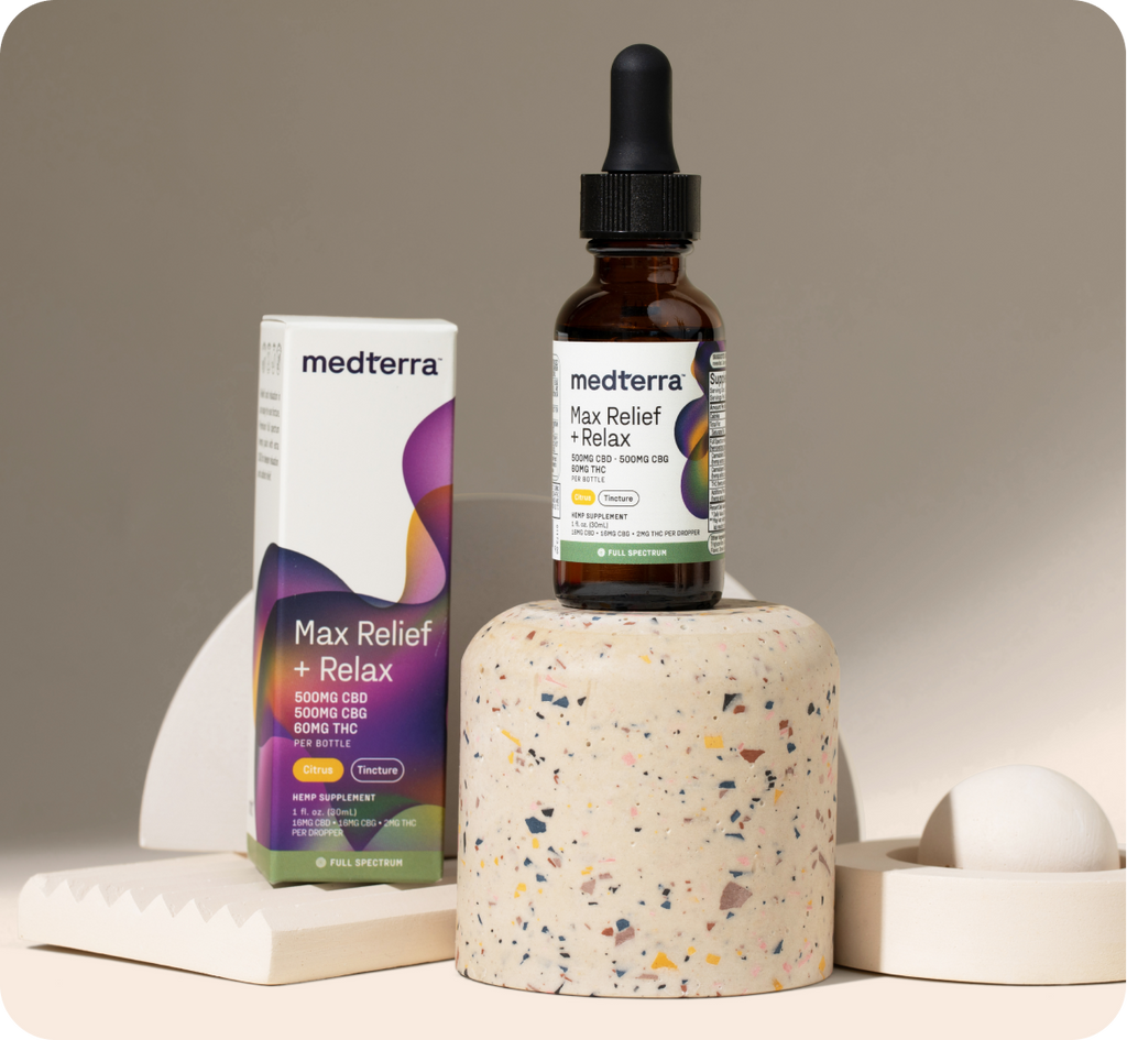 A bottle of Medterra Max Relief + Relax Full Spectrum CBD Tincture stands on a speckled cylindrical pedestal, promising a mood boost. Next to it is the product's white and purple box. The background consists of minimalist geometric shapes in neutral colors.
