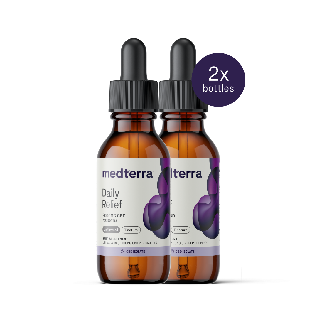 Two amber-tinted bottles of Medterra Daily Relief CBD Isolate Oil, each containing 3000 mg of isolate CBD, are shown. The bottles have black droppers and purple and white labels. A circular badge in the top right corner indicates "2x bottles.