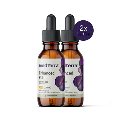 Two amber bottles with droppers labeled "Medterra Enhanced Relief Broad Spectrum CBD Oil" containing 1000mg of CBD each, stand side by side. A purple circle with text "2x bottles" is in the top right corner. The labels feature a purple abstract design and dosage information.