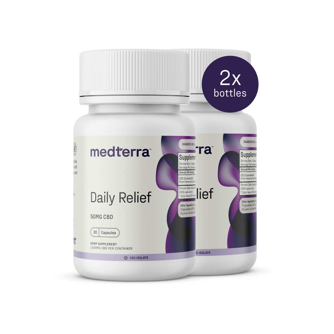Two bottles of Medterra Daily Relief CBD Isolate Capsules, each containing 50mg of CBD. The bottles are white with a purple and black wavy design, featuring screw-top lids. A circular label indicates "2x bottles." The text on the bottles reads "Dietary Supplement" and includes organic MCT Coconut Oil.