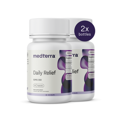 Two bottles of Medterra Daily Relief CBD Isolate Capsules, each containing 50mg of CBD. The bottles are white with a purple and black wavy design, featuring screw-top lids. A circular label indicates "2x bottles." The text on the bottles reads "Dietary Supplement" and includes organic MCT Coconut Oil.